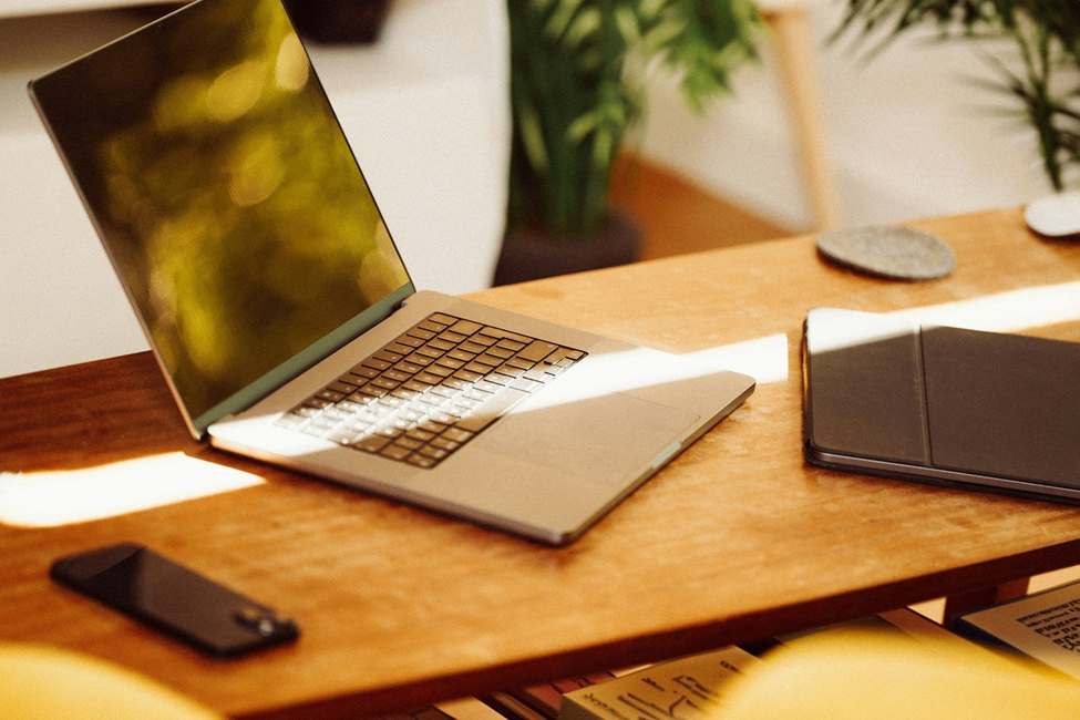 Laptop and phone on a table for the Anguilla digital nomad visa holder.